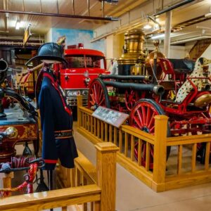 A display at the museum with old uniforms and fire fighting wagon